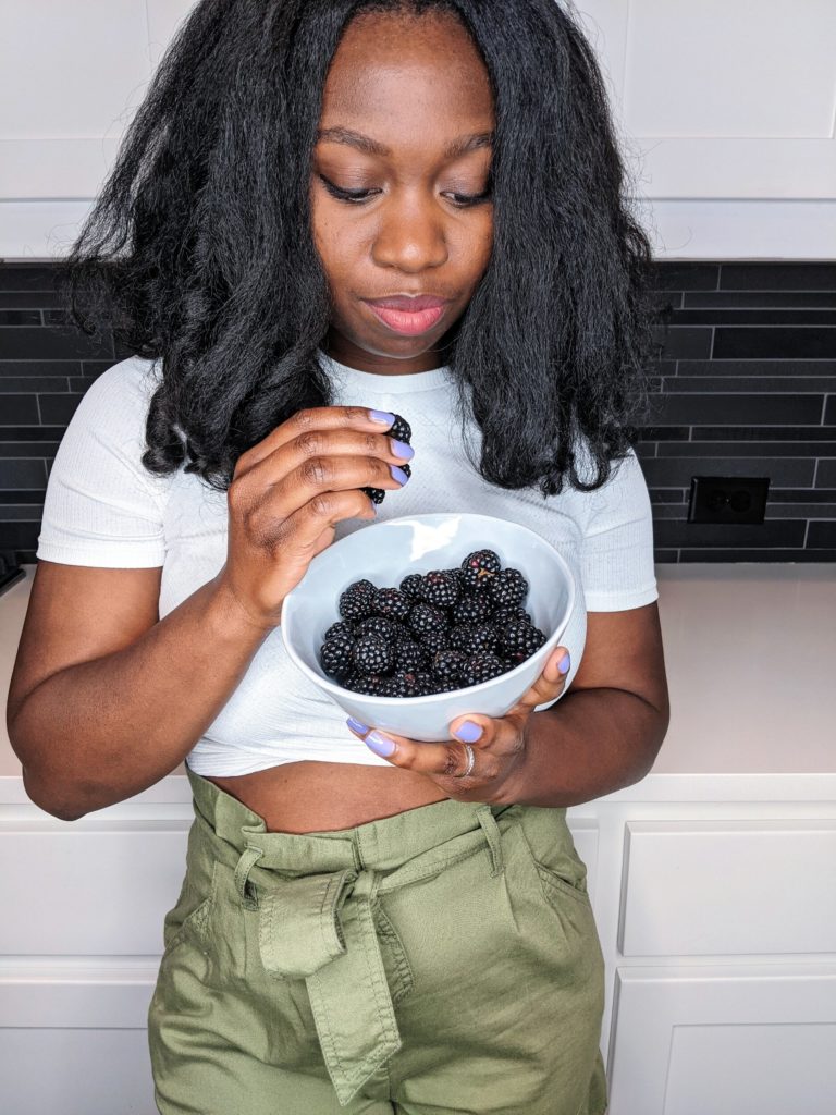 eating a bowl of organic blackberries