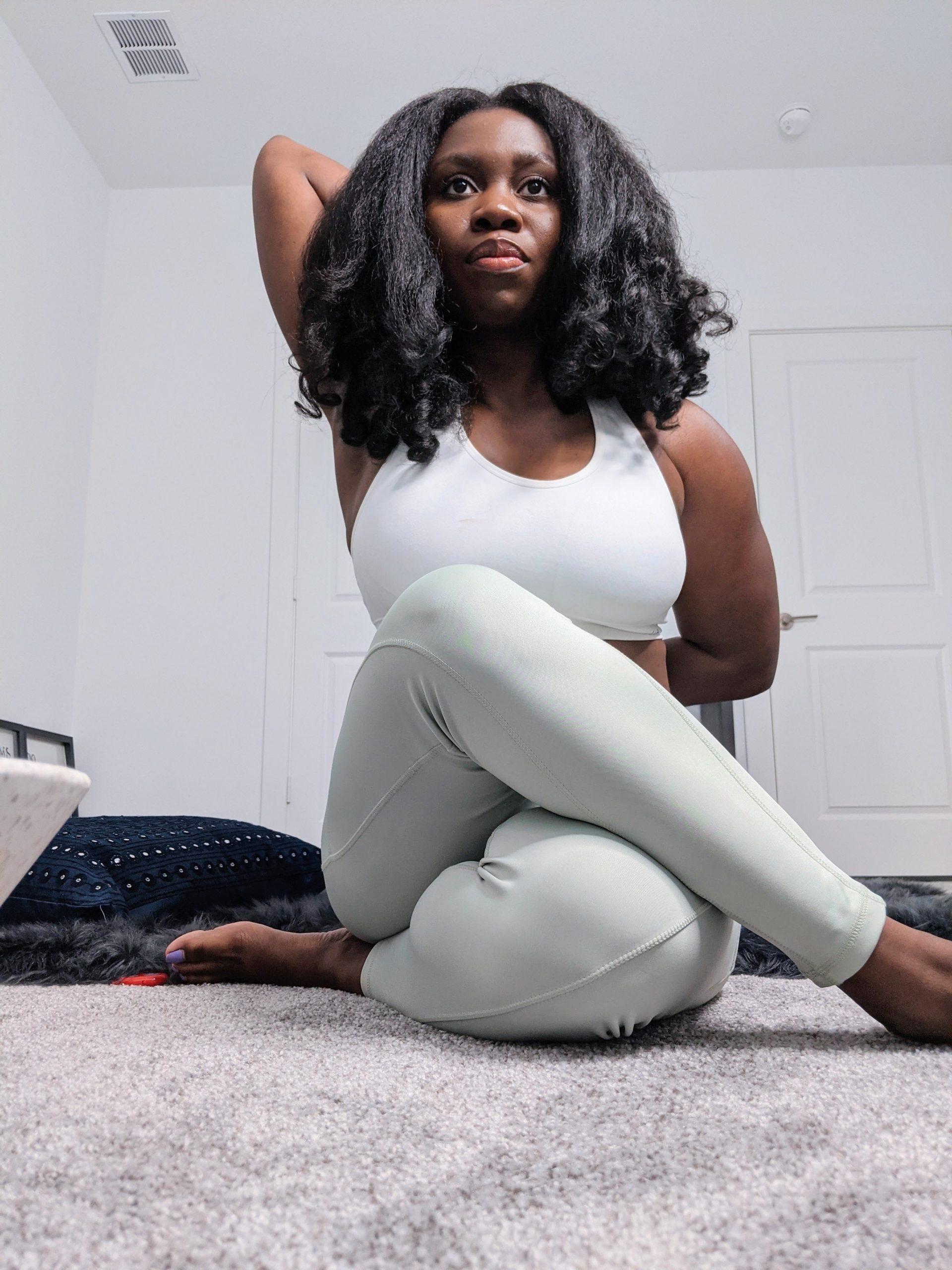 black woman practicing seated yoga pose