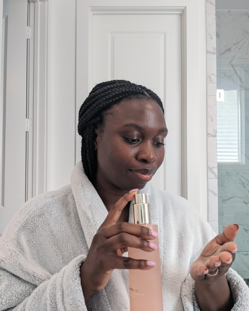 Black woman applying skincare